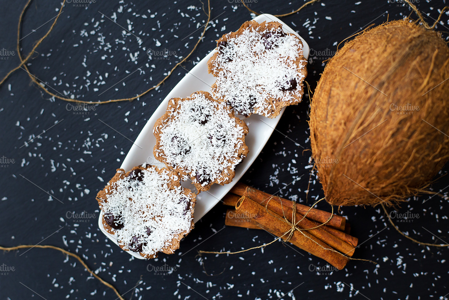 coconut muffins on a black background, a Food & Drink Photo by Artsaba Family