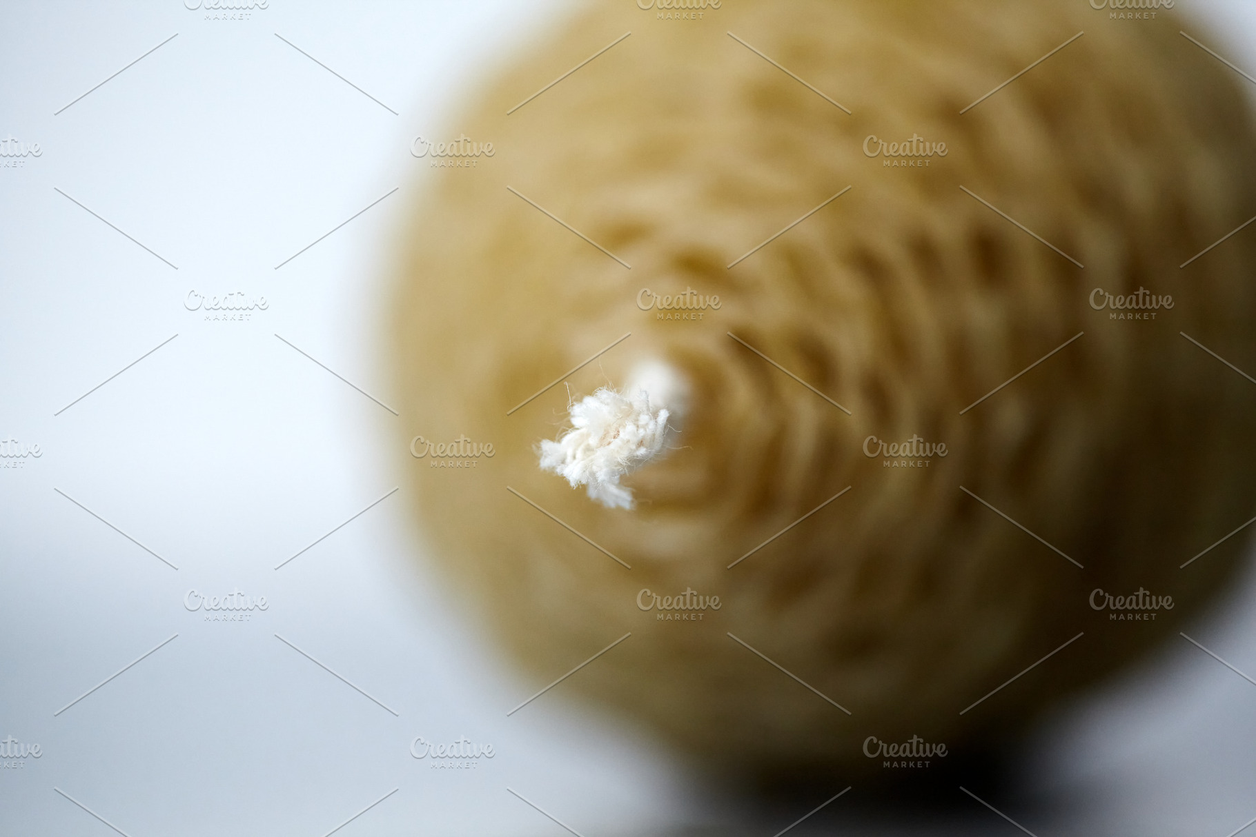 Close-up shot of a white cotton wick on a handmade beeswax egg candle with a ve, a Holiday Photo by Rohan Photography