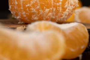 tangerines on the table, a group of peeled tangerines with juicy flesh closeup,, a Photo by rsoollAI