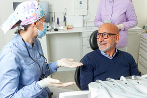 Dentist explaining something to a senior patient in the dental clinic, a Health & Medical Photo by Antonio Gravante Market
