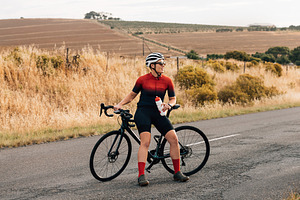 Young woman cyclist sitting, a Person Photo by Artem Varnitsin
