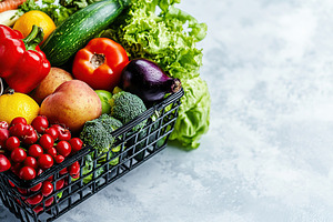 Shopping basket full of different grocery products, a Food & Drink Photo by AlyaAnd