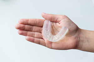 Mouth guard on a person's palm, a Health & Medical Photo by Nastya_Velko