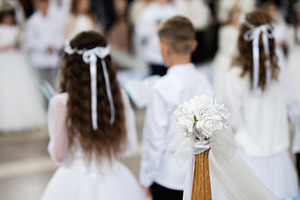 Beautiful first communion ceremony with children and floral decorations in a se, a Photo by AS photostudio