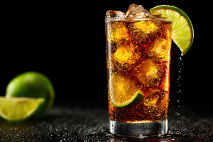 Iced Cuba Libre cocktail drink lime, a Photo by Pixeness Studio