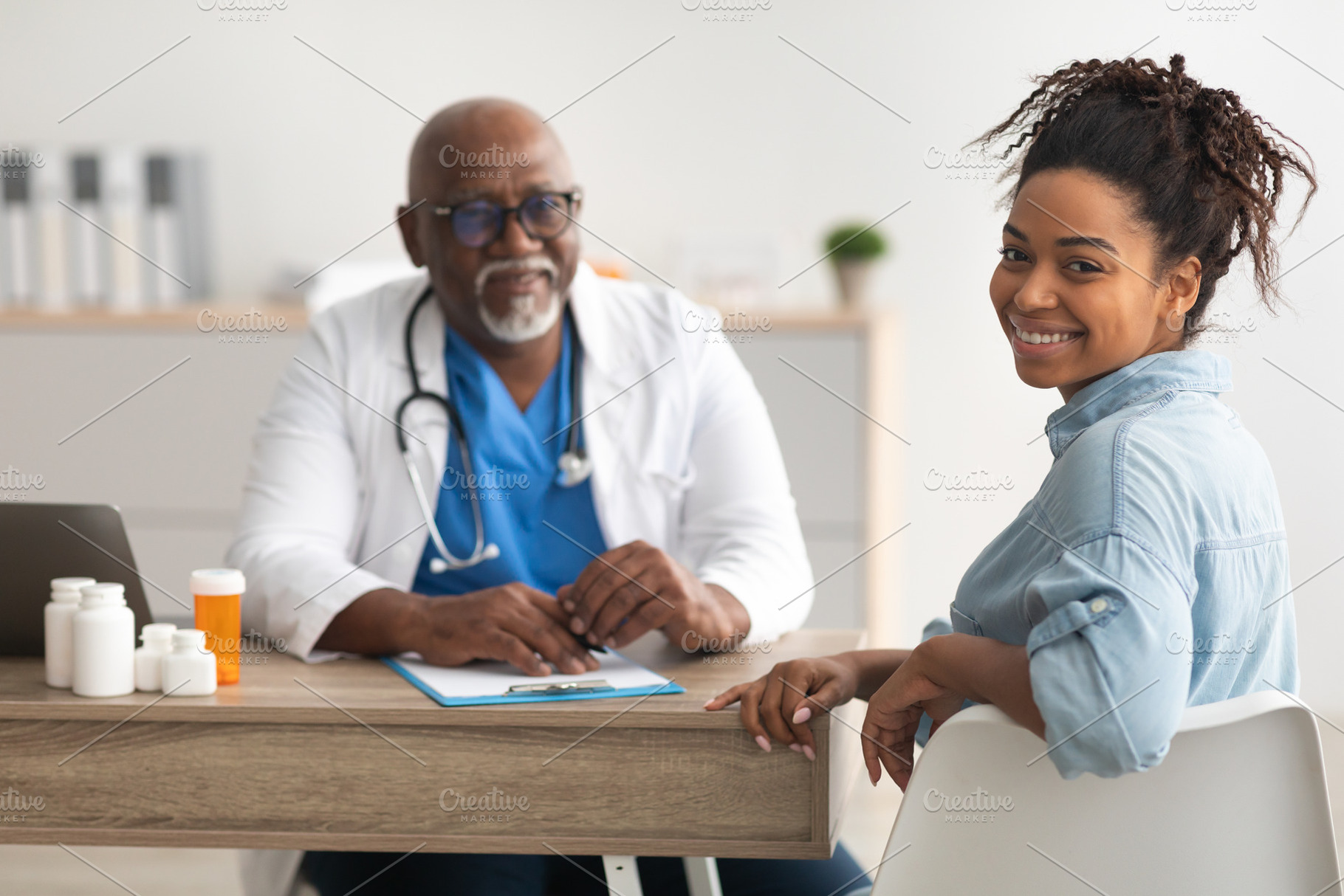 Experienced black doctor explaining treatment plan to patient, a Photo by Prostock-Studio