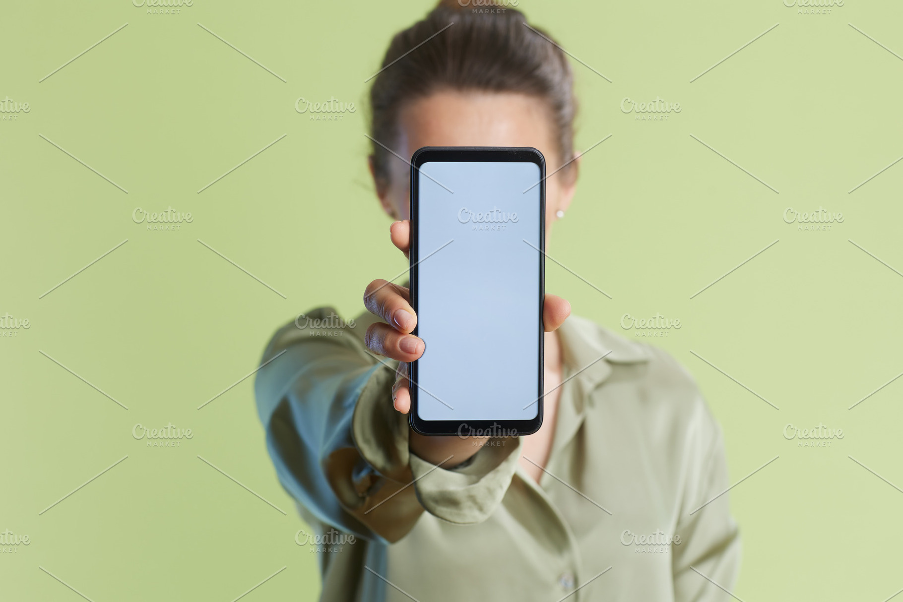 Woman Hiding Face with Smartphone, a Business Photo by Alliance Images