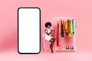 African American Lady Using Cellphone Shopping Choosing Clothes, Pink Backgroun, a Photo by Prostock-Studio (Thumbnail 3 of 4)