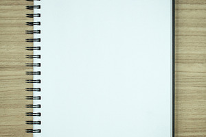 Blank spiral notebook containing notebook, paper, and notepad