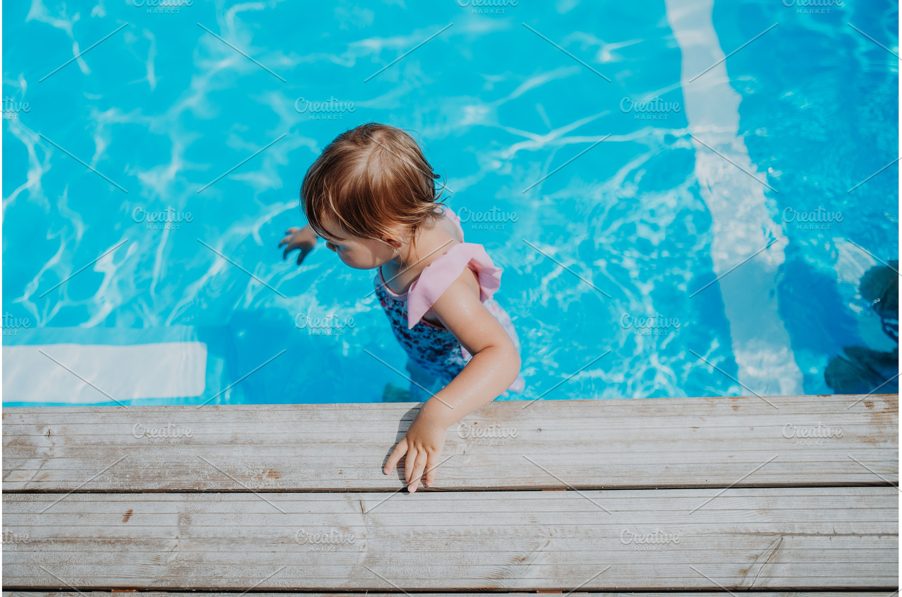 Little girl playing in shallow water, a Person Photo by HalfPoint