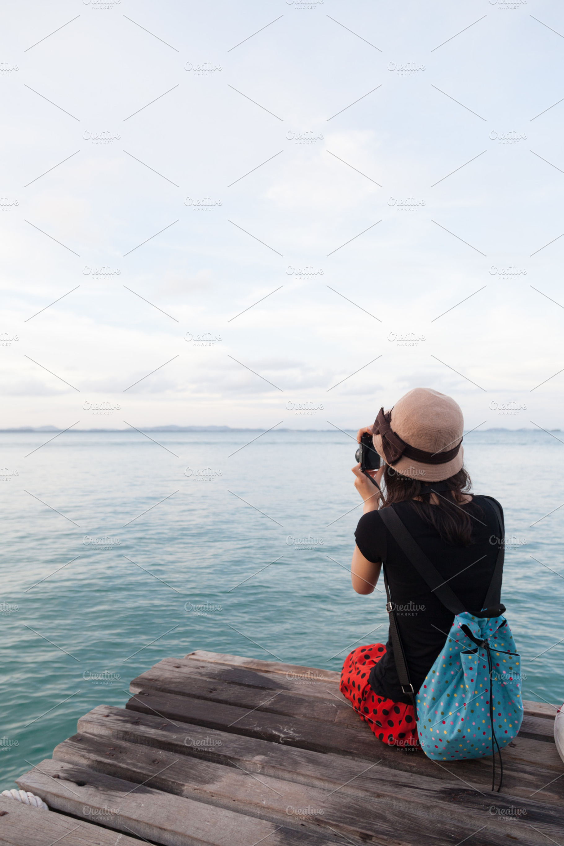 Woman photographing sea containing bridge, sea, and girl, a Person Photo by a454