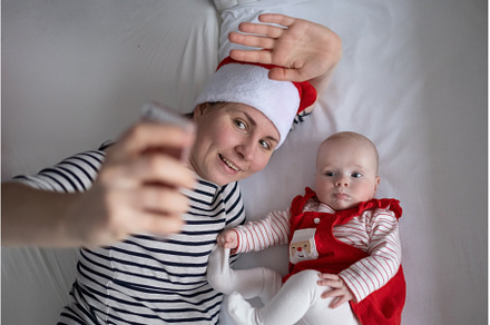 Loving young mommy making a selphie, a Holiday Photo by Koldunova