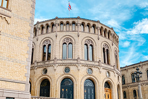 curved facade of the Norwegian Parliament in Oslo, a Photo by Nito