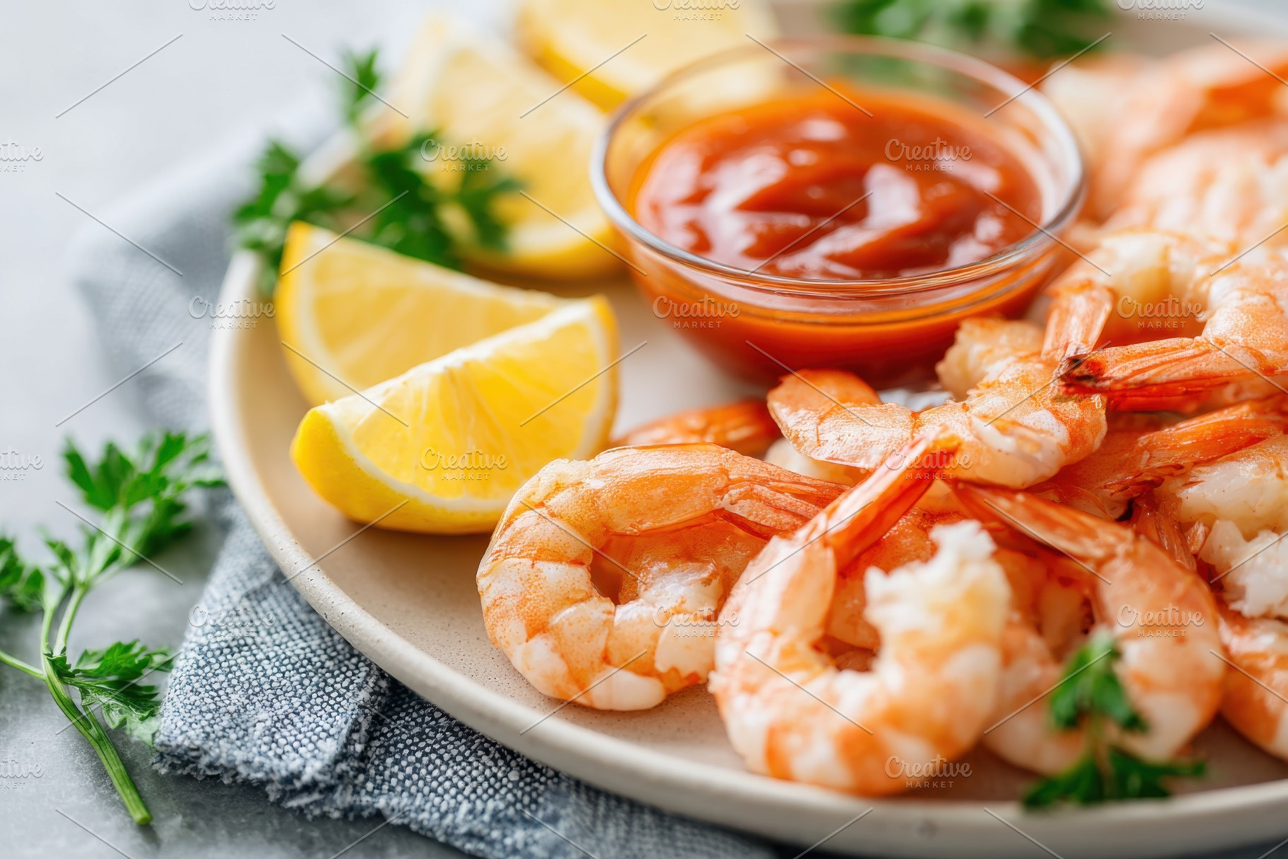 Shrimp cocktail with lemon and sauce, a Food & Drink Photo by AlyaAnd