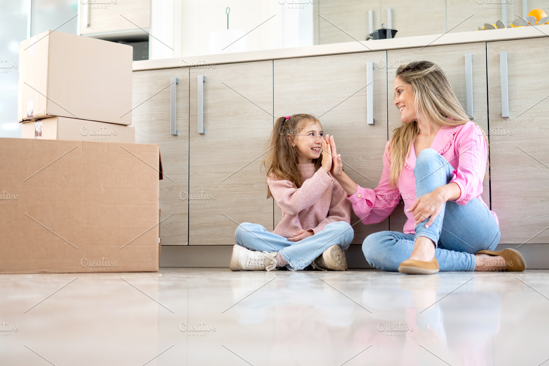 Mother and daughter celebrating move, a Person Photo by etorres69