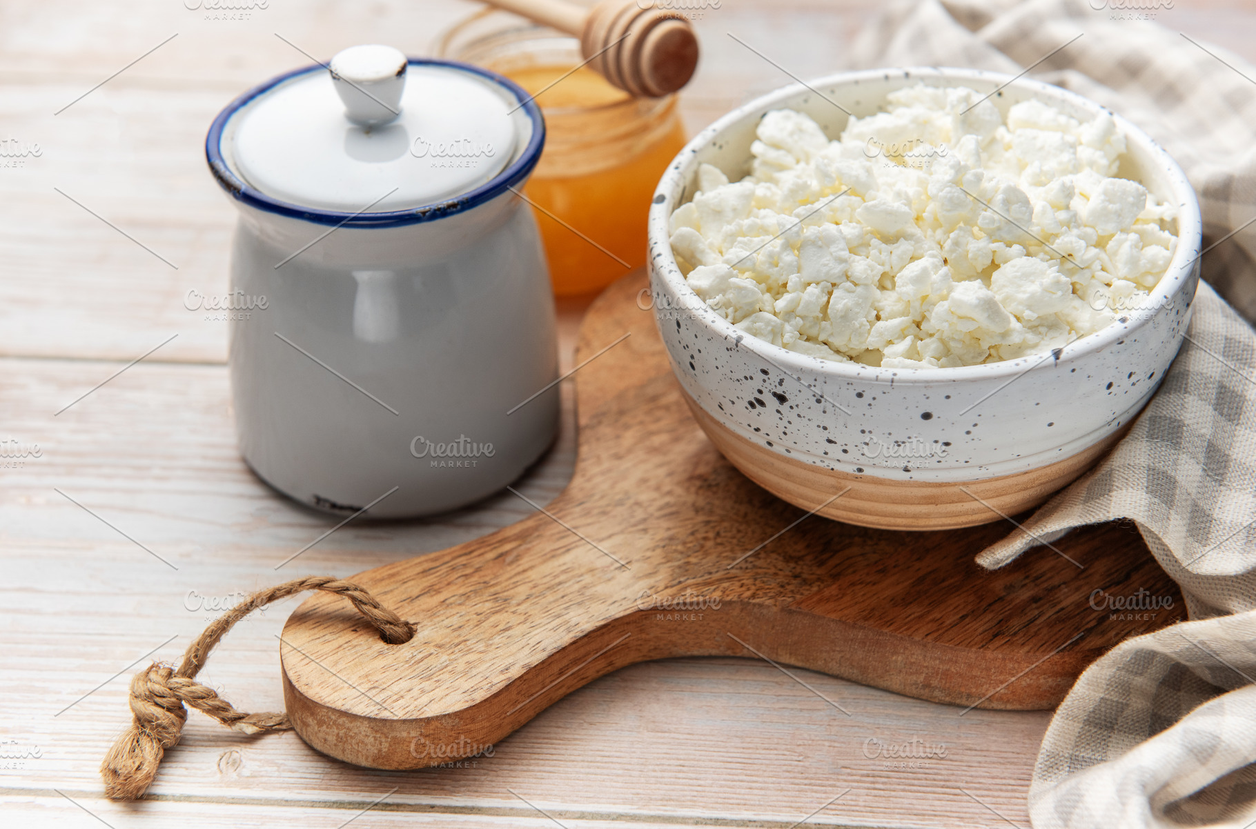 Cottage cheese in bowl with honey and sugar pot, a Food & Drink Photo by Olena Rudo