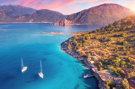 Aerial view of beautiful yachts and boats on the sea at sunset, a Nature Photo by den-belitsky