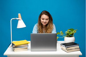 Focused woman working at desk with, a Person Photo by volodymyrshtun13795