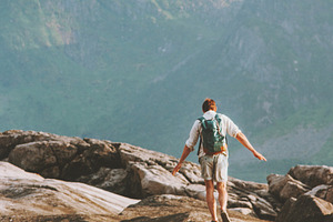 Man backpacker hiking in Norway summ