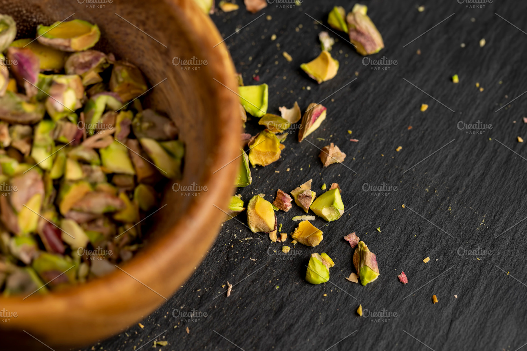 pistachios chopped and crushed into pieces of different sizes, a bunch of crunc, a Photo by rsoollAI