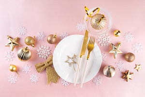 Christmas, New Year table setting with plate, drinking glass, cu