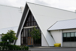 Modern church building with angular roof design in Reykjavik, Iceland under clo, a Photo by AS photostudio