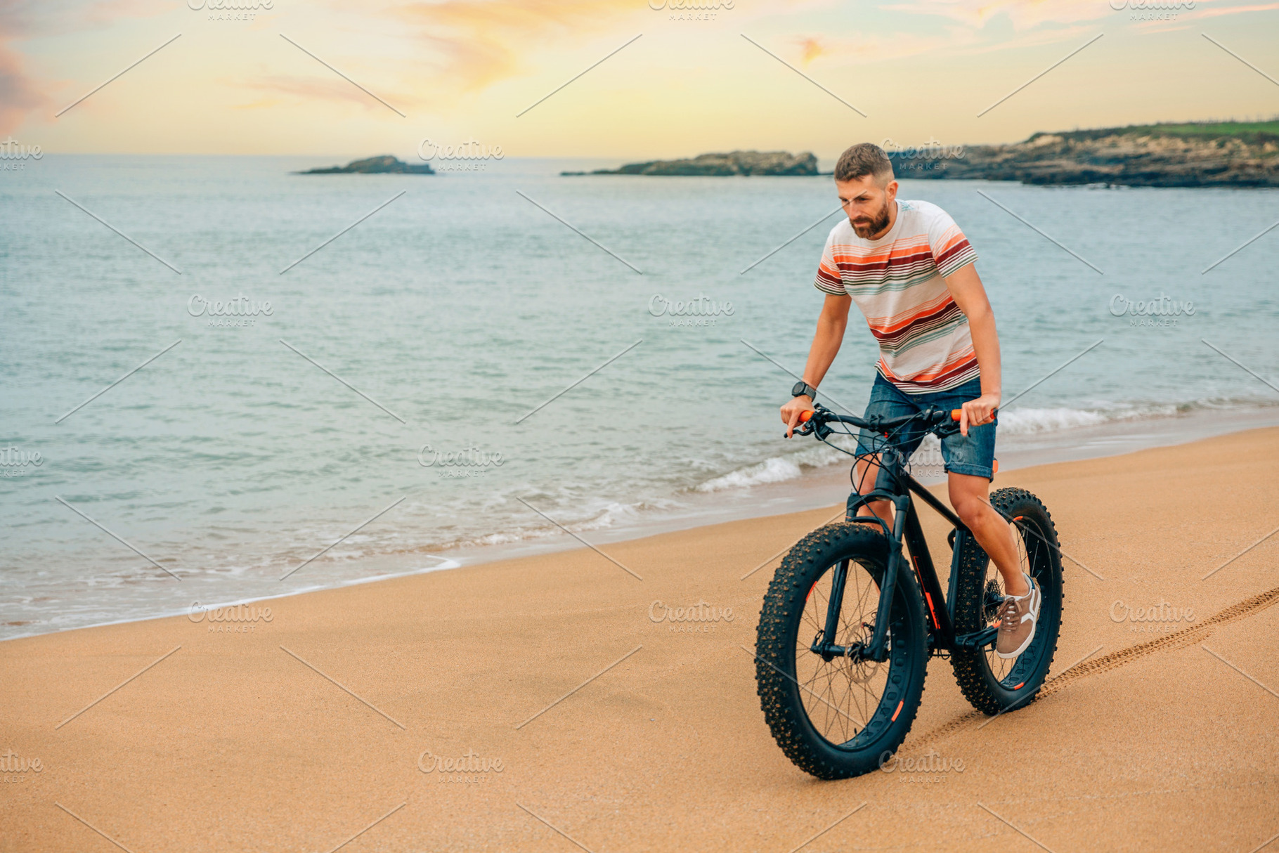 Man riding a fat bike on the beach, a Transportation Photo by