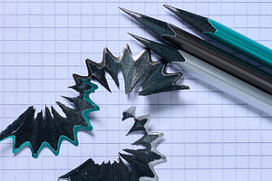Wooden pencil shavings and a pencil lying on a paper background, a School & Education Photo by ndanko