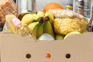 A cardboard box filled with food and water bottles, a Food & Drink Photo by ndanko