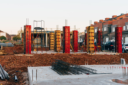 Construction site with steel formworks and reinforcing bars for pillars ready f