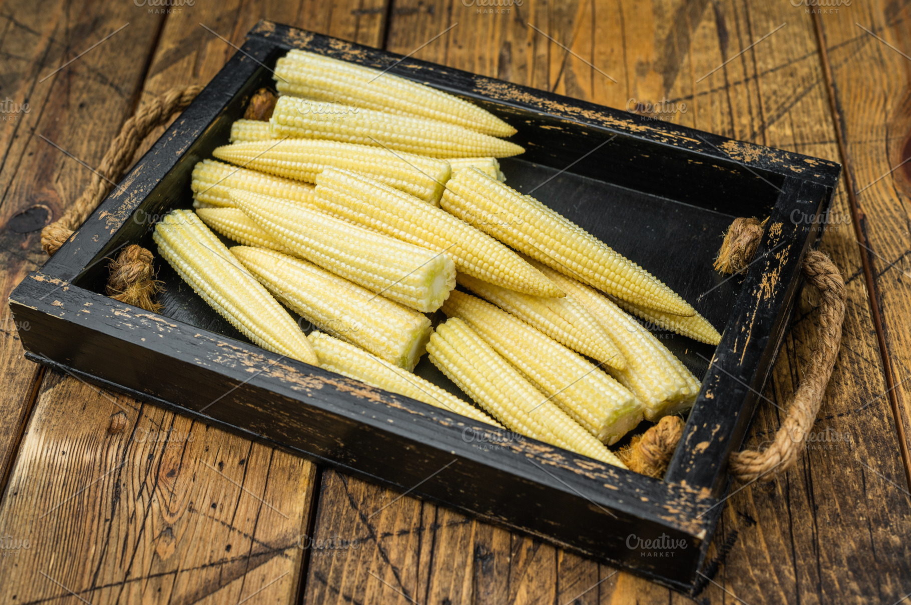 Whole uncooked baby corn in wooden crate on rustic table with th, a Food & Drink Photo by composter-box@mail.ru