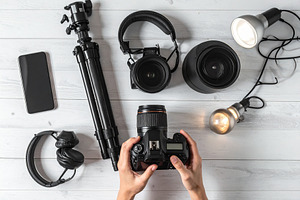 Wooden desk with hand handling with filming equipement, a Technology Photo by DanFLCreativo