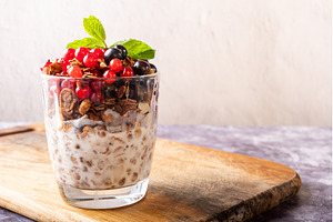 Healthy granola with milk, fresh red, a Food & Drink Photo by Stockphoto by vzwer