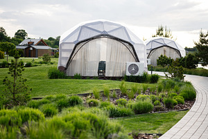 Modern geodesic dome accommodations in a serene greenery-filled resort setting, a Photo by AS photostudio