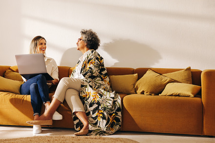 Two happy businesswomen working in an office lobby