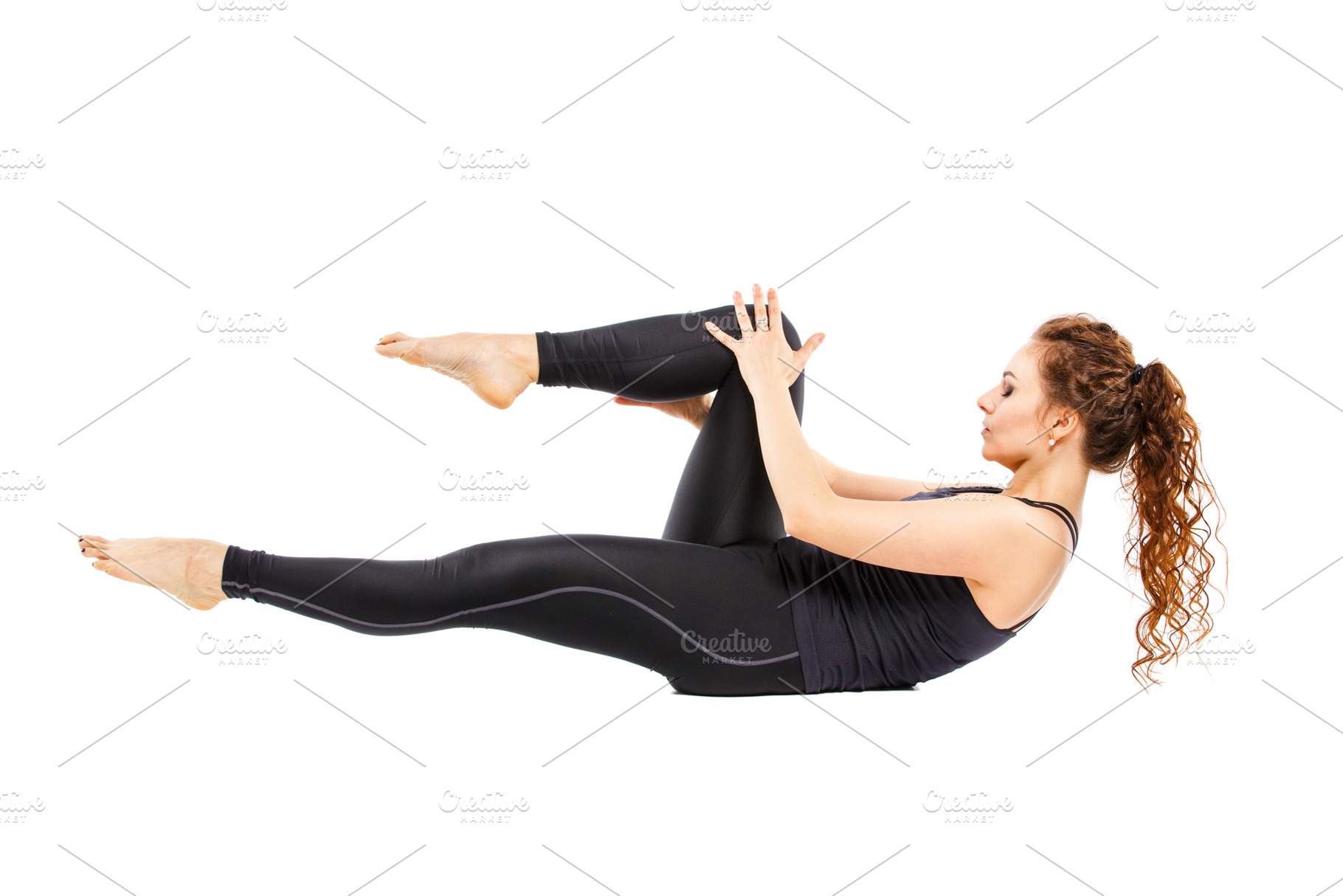Young fit woman doing pilates on white background containing balance, a Sports & Recreation Photo by serkum