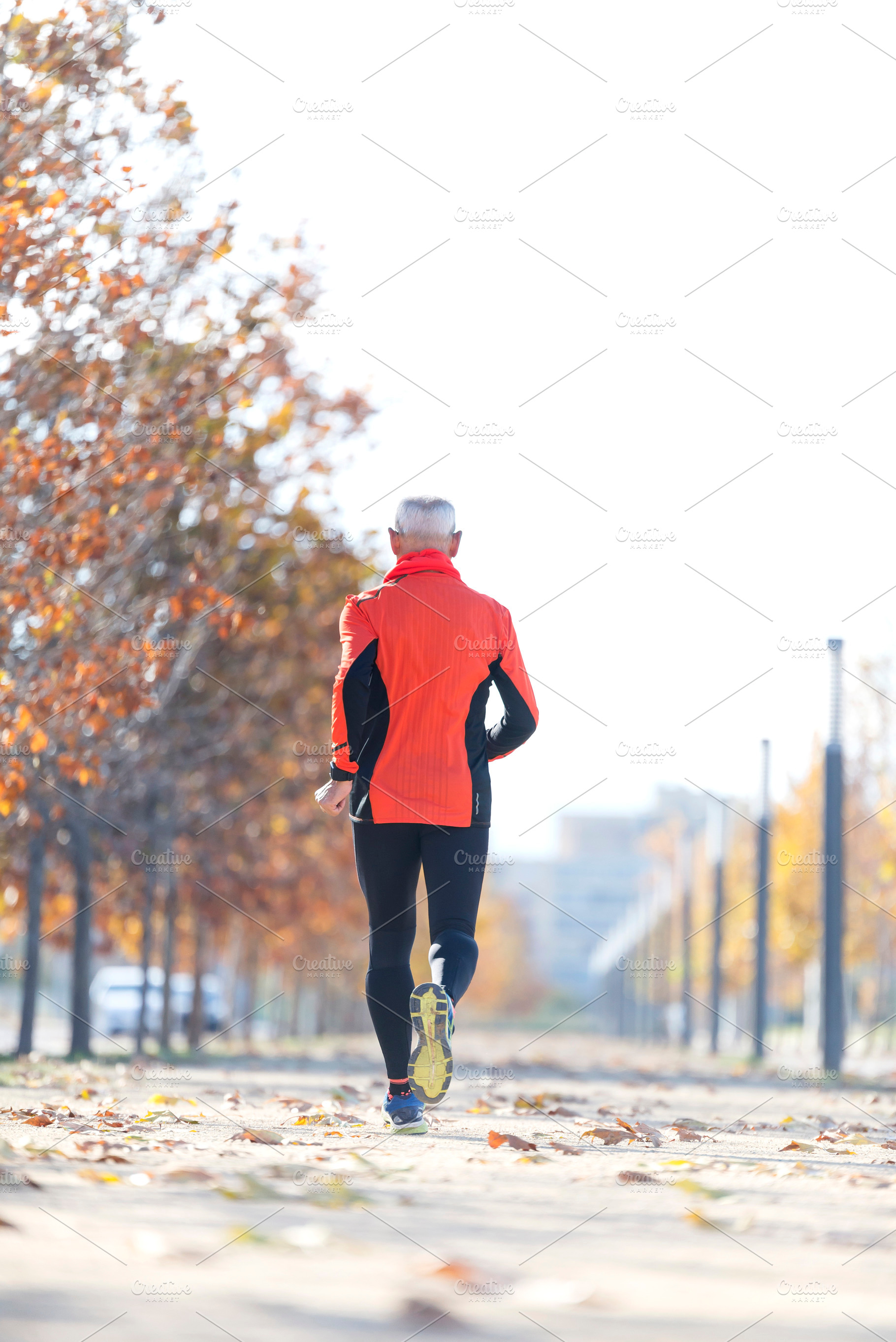 Senior man jogging in the park on a sunny day, a Sports & Recreation Photo by RF Images