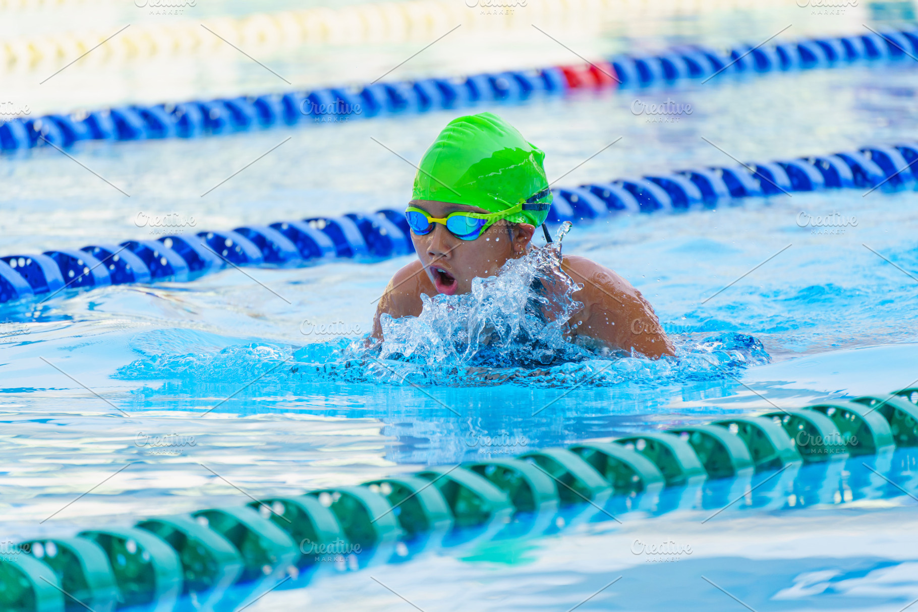 Swimmer child swims breaststroke swimming style in a race swimmi, a Sports & Recreation Photo by Casanowe-studio