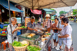 Asian multicultural group of tourists gathered around a busy str