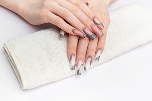 Woman's hands showing long gray and white nails, a Beauty & Fashion Photo by Olena Rudo