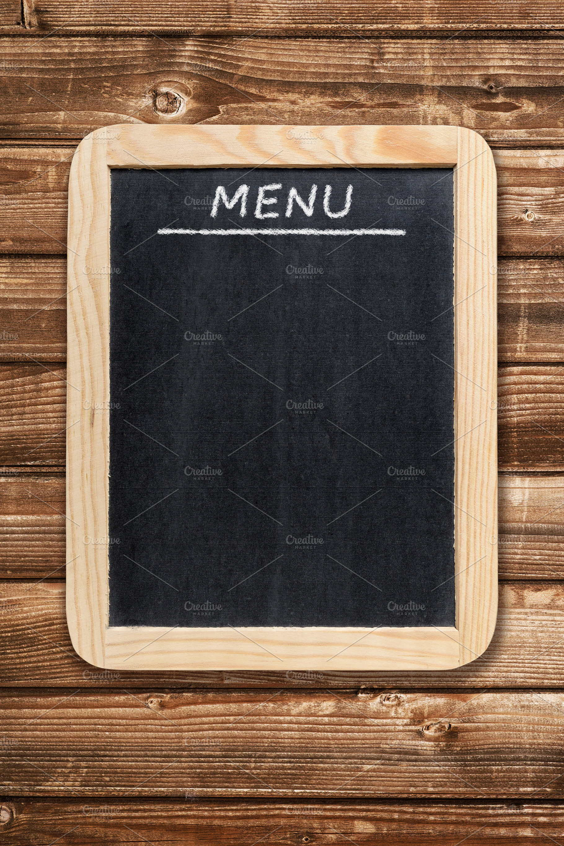 Menu board on wooden background, a Food & Drink Photo by Anatoliy Sadovskiy