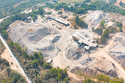 Aerial view of machine excavator trucks dig coal mining or ore w, a Background Photo by Tampatra