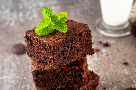 Stack of chocolate brownies with milk glass on dark stone backgr, a Food & Drink Photo by vimart