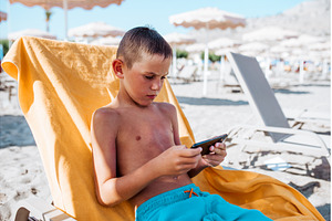 Boy relaxing on beach lounger, a Nature Photo by HalfPoint