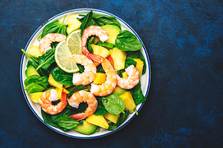 Fresh pineapple salad with shrimps, spinach, avocado and lime on, a Food & Drink Photo by 5PH