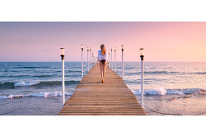Happy young woman in bikini walking, a Person Photo by den-belitsky