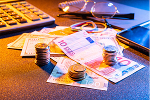 Close-up of coin stacks on banknotes, a Business Photo by Stockphoto by vzwer