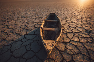 Boat sits on dry cracked earth under, a Photo by Pavel_design