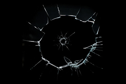 Shattered glass surface with sharp, jagged edges radiating from a central point, a Background Photo by Textures & Backgrounds