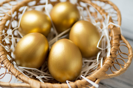 Golden eggs in a wooden wicker baske featuring eggs, gold, and easter, a Holiday Photo by PavelKant